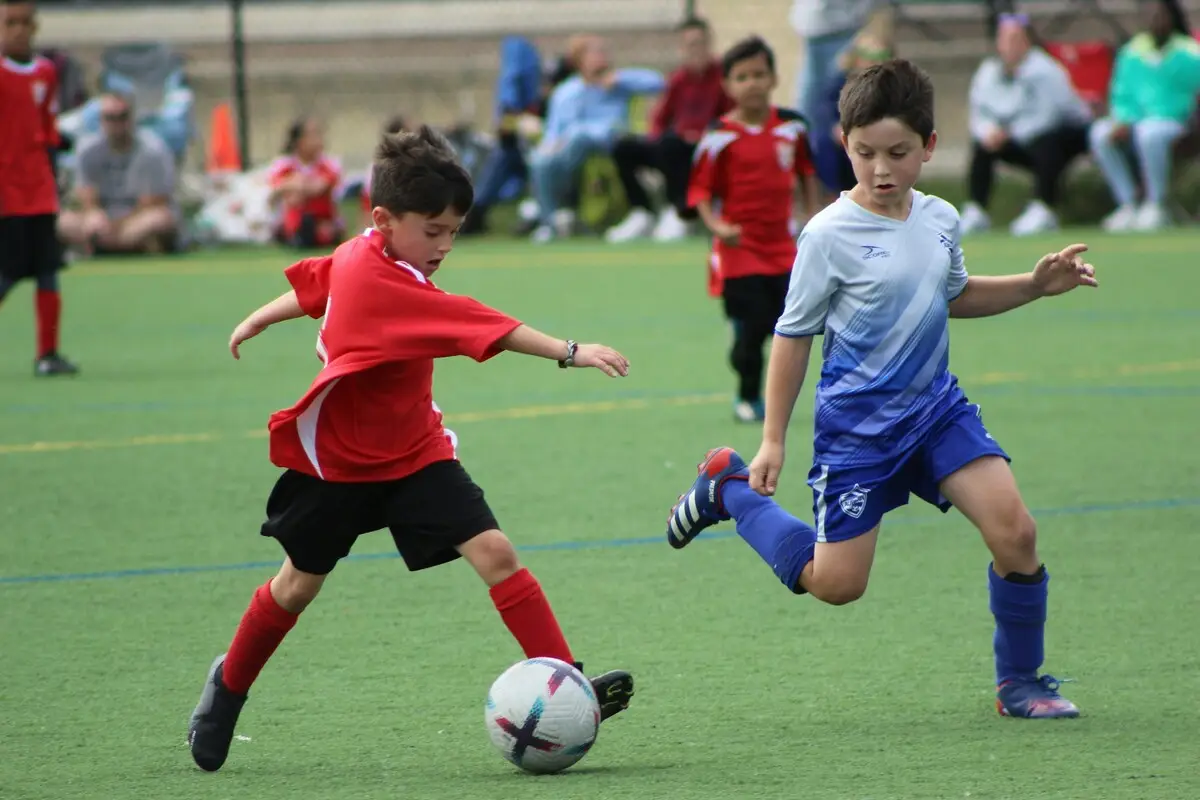 Youth soccer players competing for the ball during a match